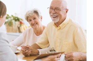 smiling senior couple with home improvement rep