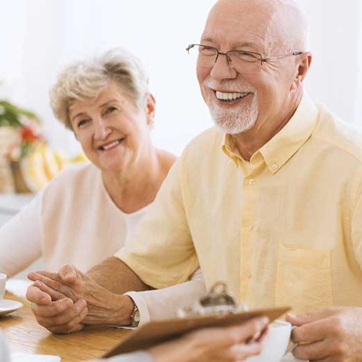 smiling senior couple with home improvement rep